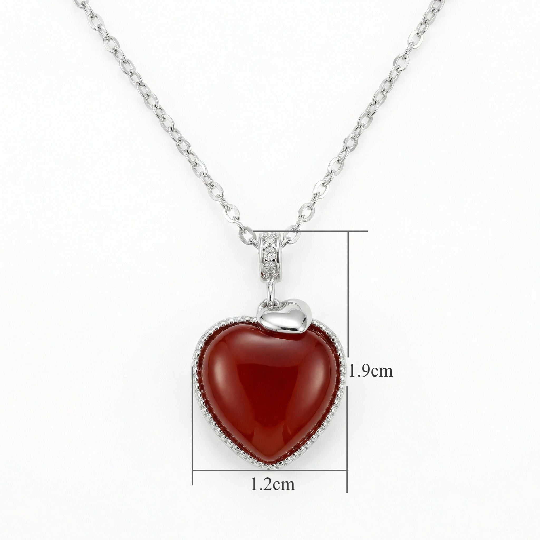 Close up of a 925 Sterling Silver heart necklace featuring a vibrant red gemstone pendant with clear crystals.