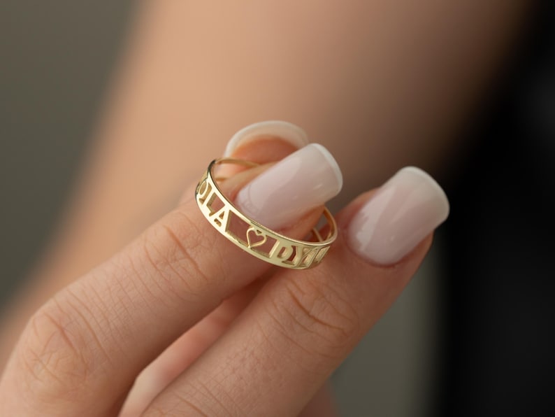 Minimalist gold-tone bracelet featuring a personalized Punjabi script name design on a clean white background.