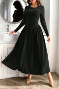 Close-up of a black ruched round neck long sleeve dress showing the figure-flattering detailing.