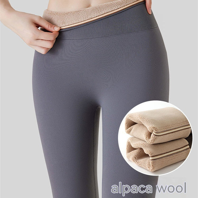 Close-up of woman wearing high-waist fleece-lined thermal leggings with a view of the plush interior lining