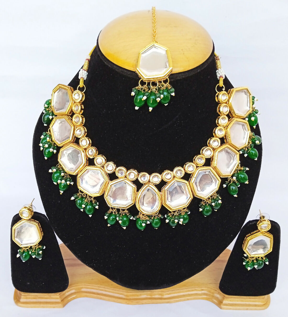 Green Kundan necklace set with gold-plated detailing and adjustable cord for elegant ethnic styling