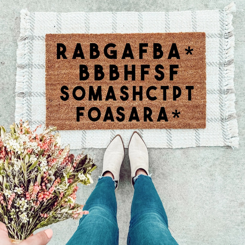 Natural coir doormat with RABGAF text, featuring a brown textured surface for farmhouse entryway decor.