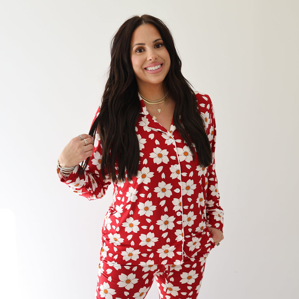 Woman wearing a red and white cherry blossom print bamboo button-up lounge set with long sleeves and flare pants