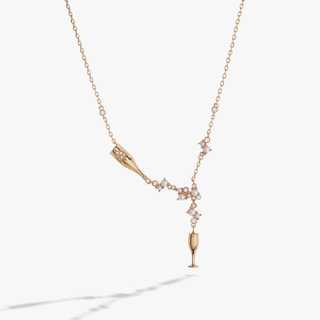 Champagne bottle and flute pendant necklace featuring pearls and clear crystals on an adjustable chain.
