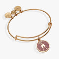 Gold expandable wire bangle featuring a pink glitter champagne glasses charm for New Year's Eve.