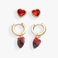 Set of two pairs of earrings featuring chocolate box posts and crystal-embellished chocolate strawberry huggie hoops.