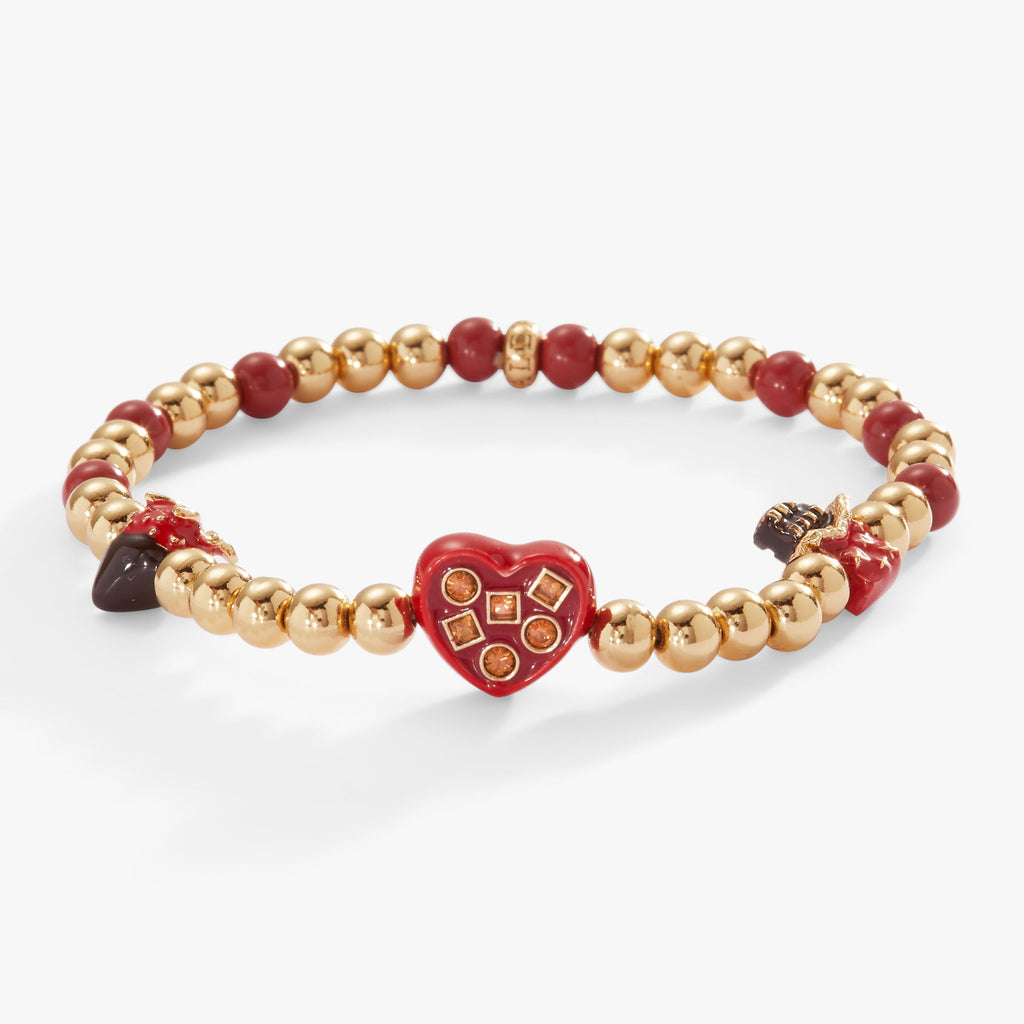 Gold-tone stretch charm bracelet featuring chocolate-themed charms including a strawberry and chocolate bar.