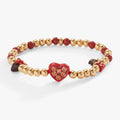 Gold-tone stretch charm bracelet featuring chocolate-themed charms including a strawberry and chocolate bar.