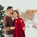 Natural wood Terra travel map decorated for the Christmas season on a wall