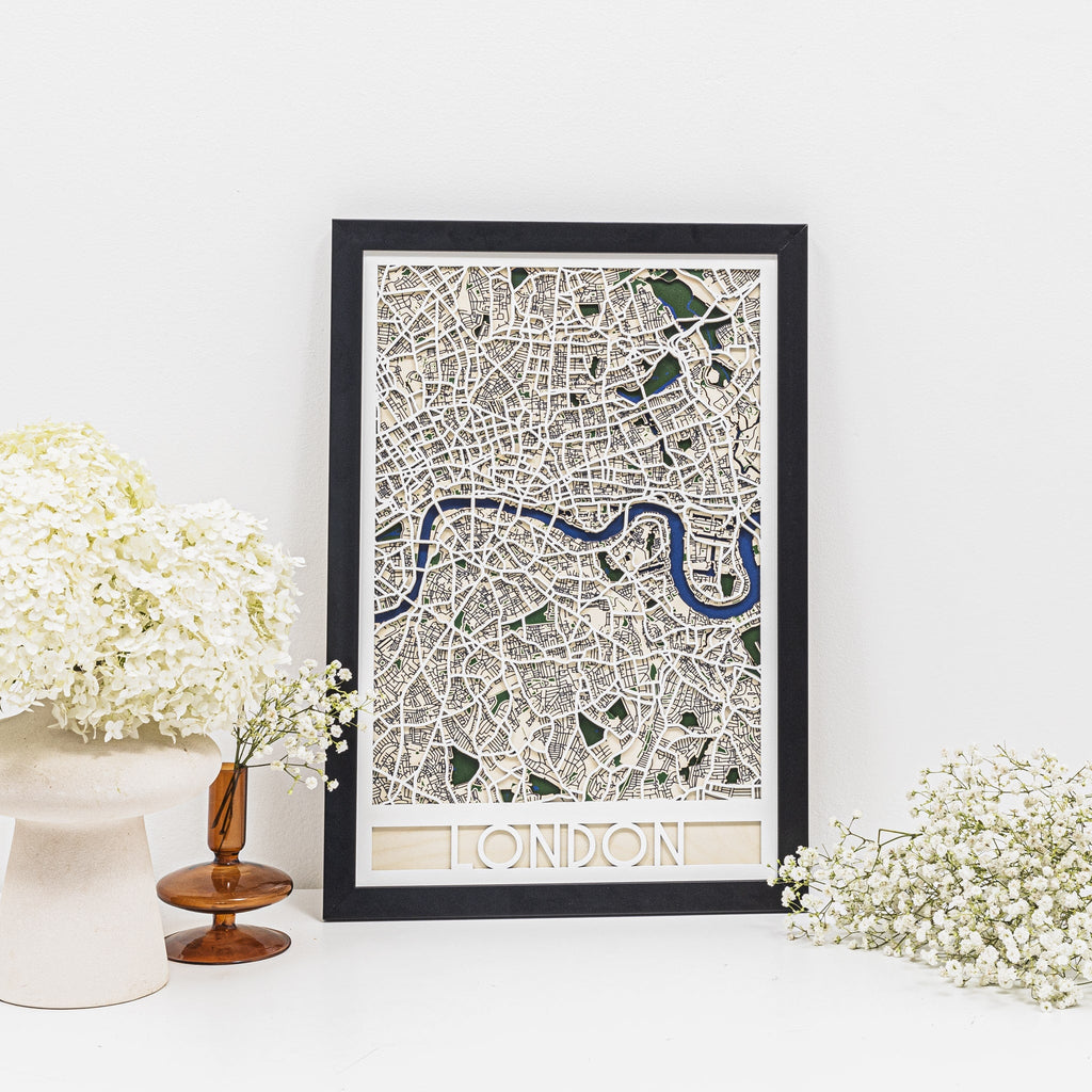 Modern 3D geometric map of London in black, white, and blue with milestone pins.