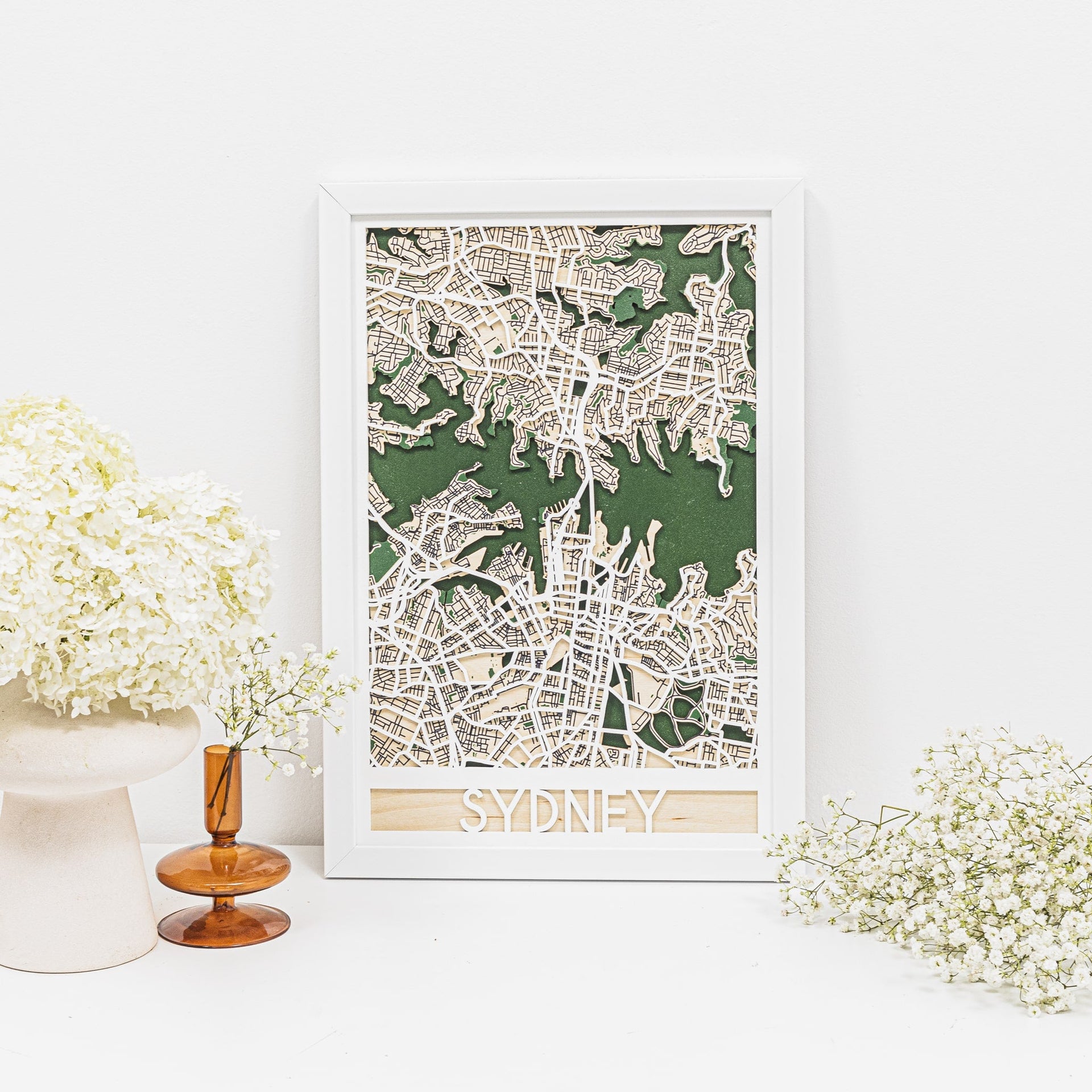 3D Sydney city map made of wood with green and white details on a minimalist wall