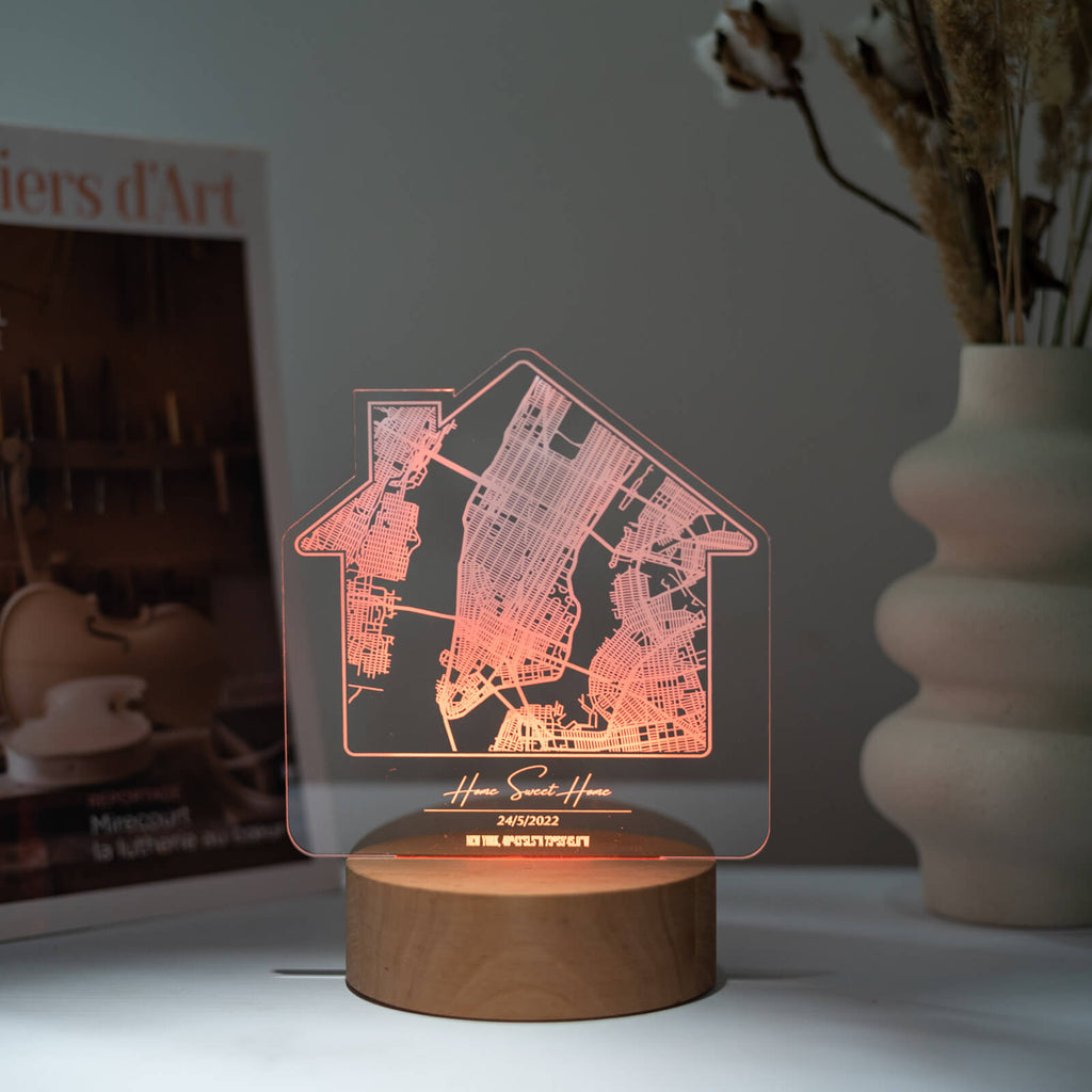 Personalized City Plan Light Stand on a wooden surface showing an engraved urban map layout with warm ambient light.
