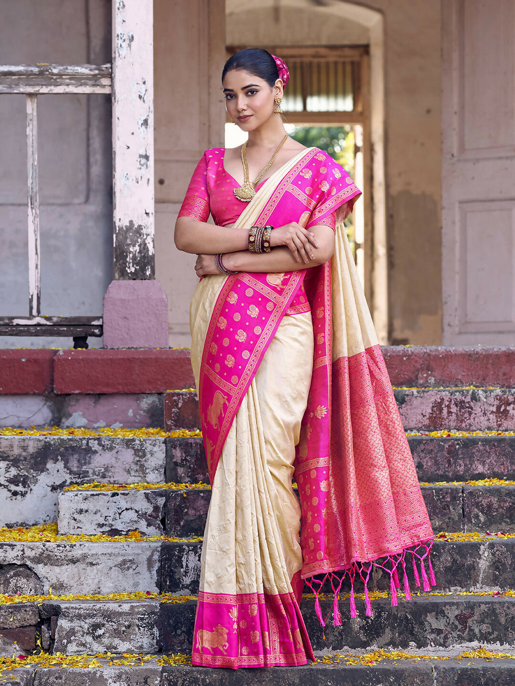 Cream soft silk saree paired with a contrasting pink blouse piece