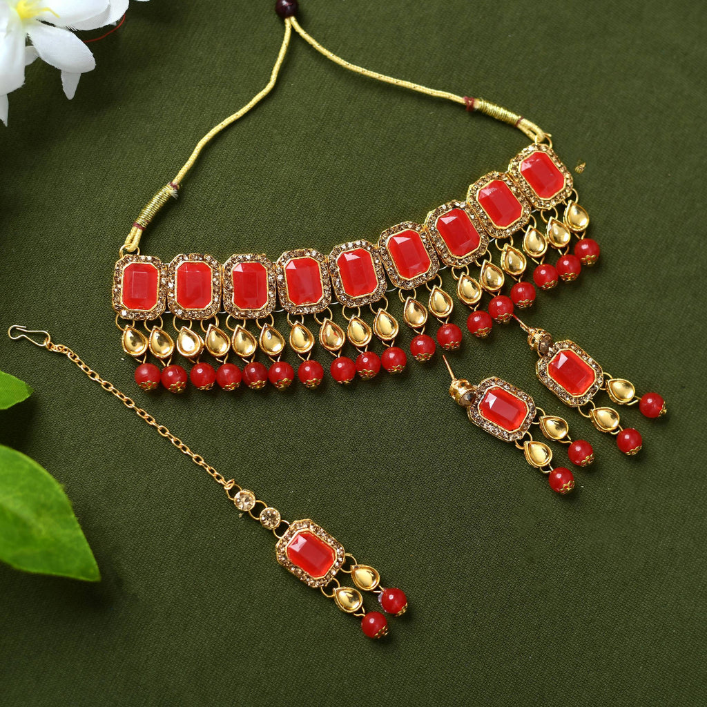 Gold-polished Kundan and pearl choker with red accents