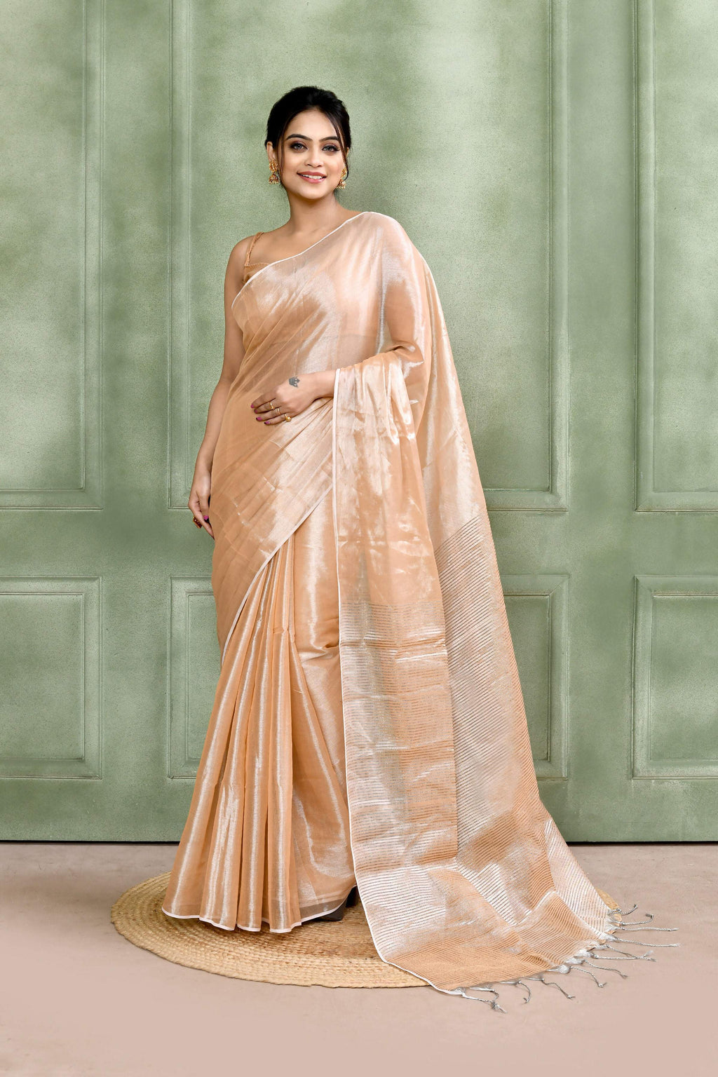 Beige dual tone organic tissue saree with matching blouse piece draped elegantly
