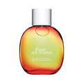 Clarins Eau des Jardins Treatment Fragrance bottle in a gradient orange and yellow sunset-toned glass.