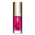 Clarins Lip Comfort Oil in Raspberry shade, showing a glossy, sheer red lip oil applicator.