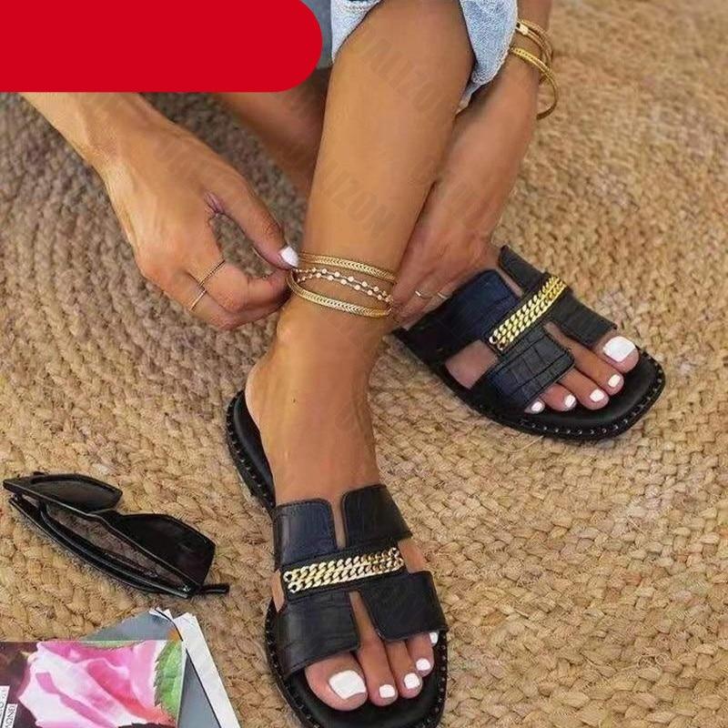 Women wearing minimalist gold double chain flat flip-flop sandals