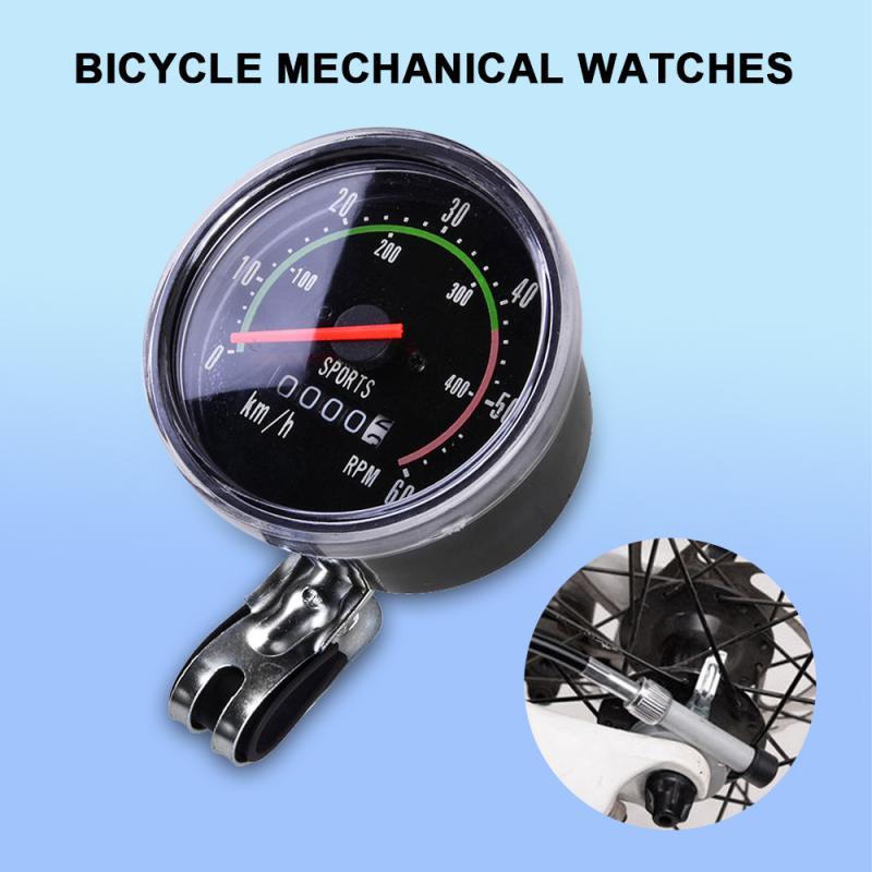 Close up of a classic vintage mechanical bicycle speedometer on handlebars.