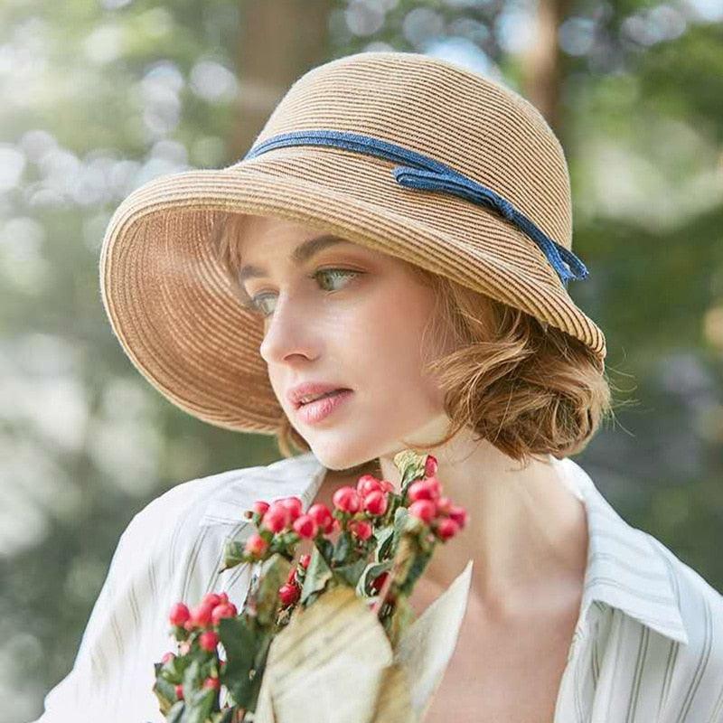 A vintage-inspired wide brim straw hat for women, foldable and perfect for summer travel.