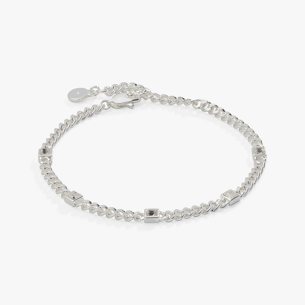 April birthstone bracelet featuring bezel-set clear crystals on a stainless steel curb chain