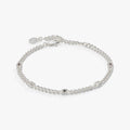 April birthstone bracelet featuring bezel-set clear crystals on a stainless steel curb chain