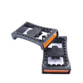 High-performance clipless bike cleats in black and orange for cycling shoes.
