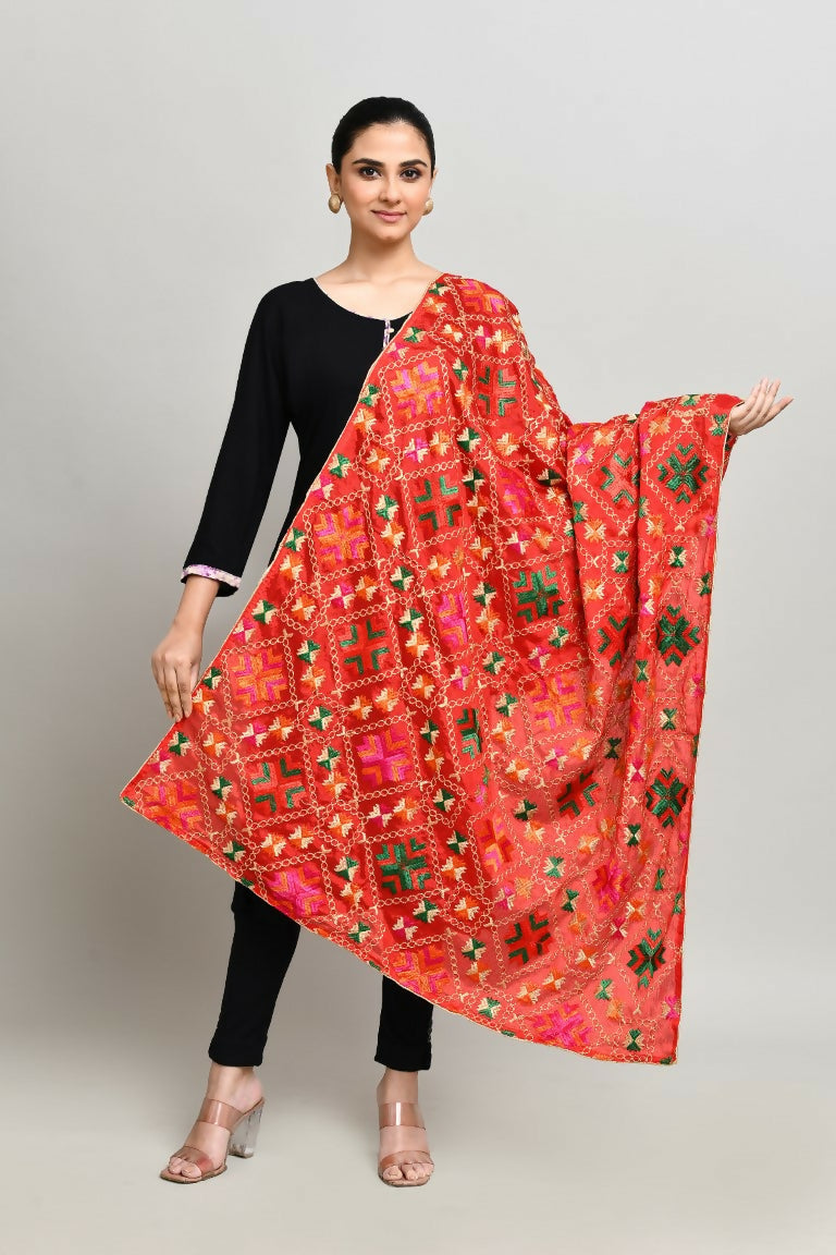 A vibrant red cotton Phulkari dupatta with multi-color geometric embroidery and metallic gold accents.