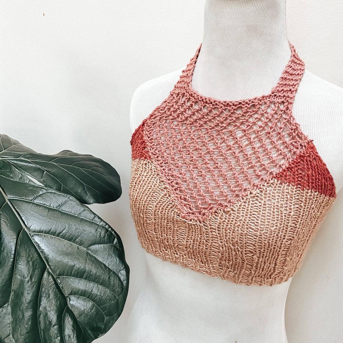 Close up of the Coconut Tree Knit Bralette pattern in a terracotta color, featuring a halter neckline and tie closure.