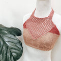 Close up of the Coconut Tree Knit Bralette pattern in a terracotta color, featuring a halter neckline and tie closure.