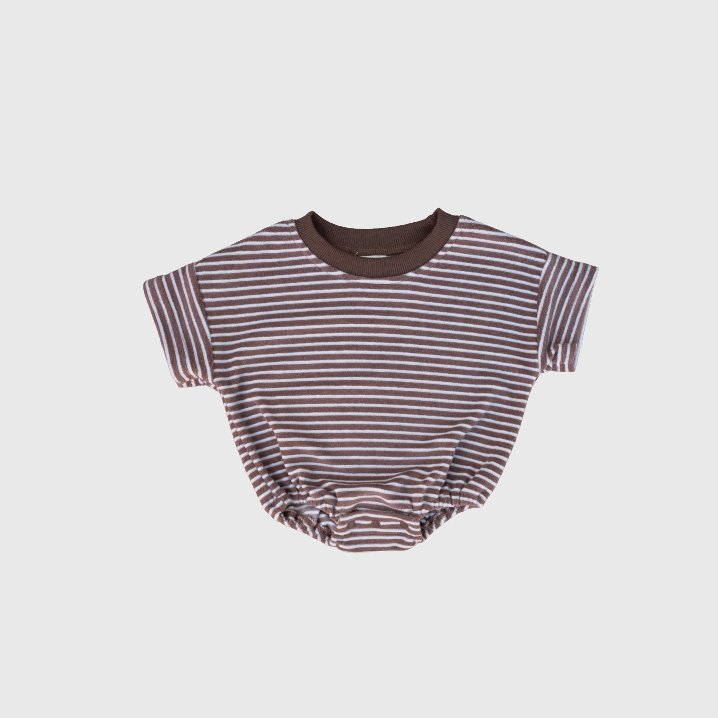 Baby wearing a minimalist cola and white striped short-sleeve terry romper with crew neckline