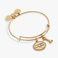 Gold-tone charm bangle featuring a Cold Nose Warm Heart medallion with pave border