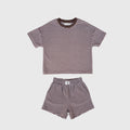 Child wearing a soft cola brown and white striped terry short set, perfect for active play