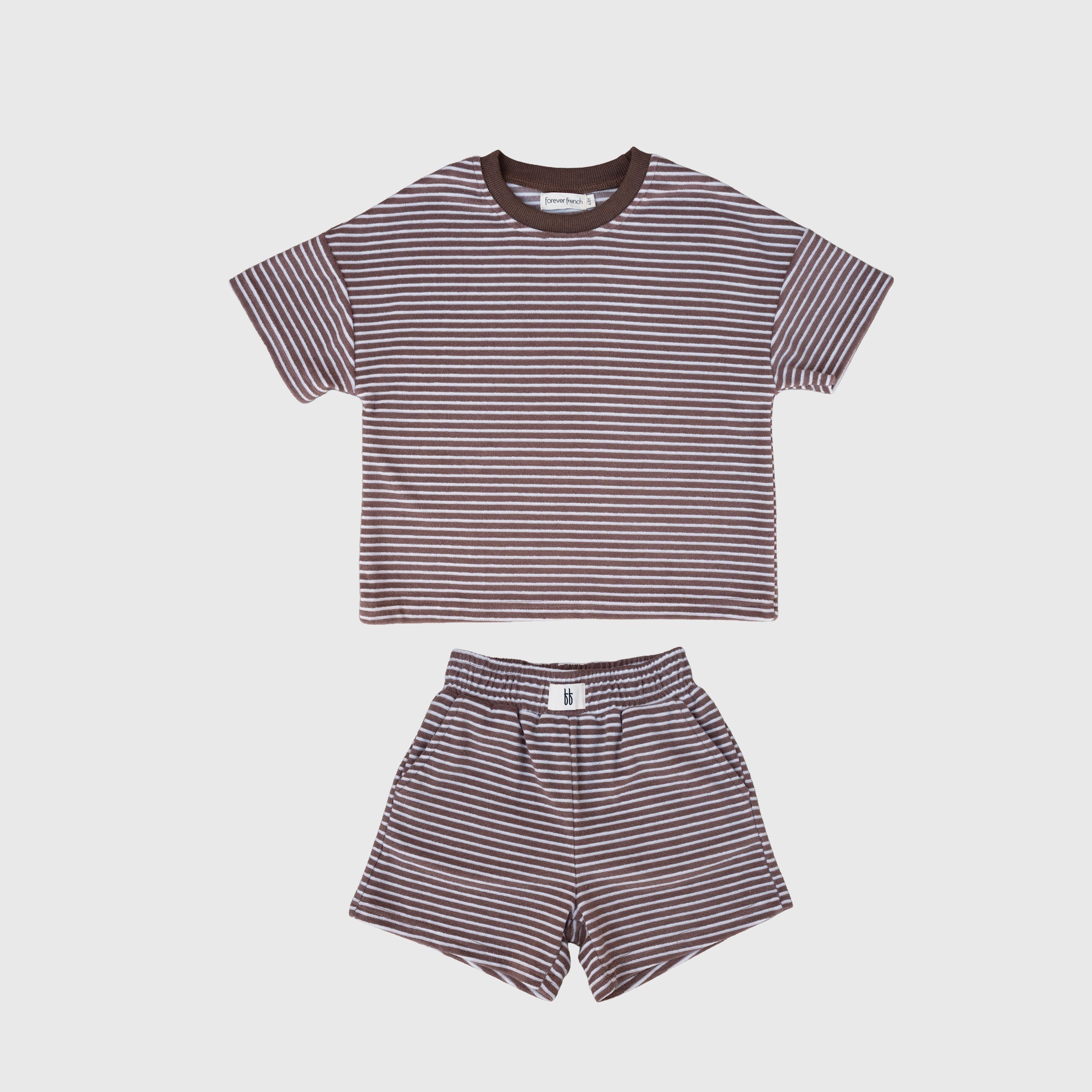 Child wearing a soft cola brown and white striped terry short set, perfect for active play