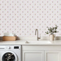 Conley floral wallpaper with pale blue, pink, and green accents on an off-white background.