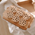 Minimalist wooden toy cookie set with six chocolate chip cookies on an alder wood tray for children.