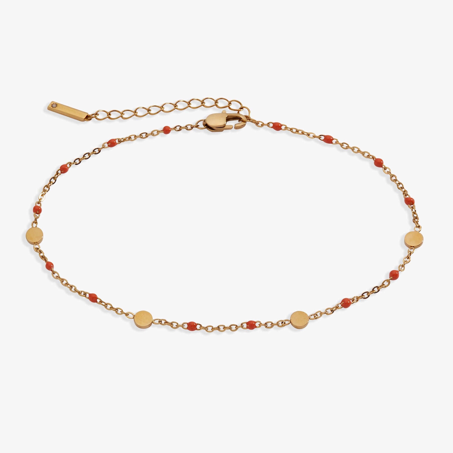 Gold-plated anklet with vibrant coral enamel coin stations for charm display