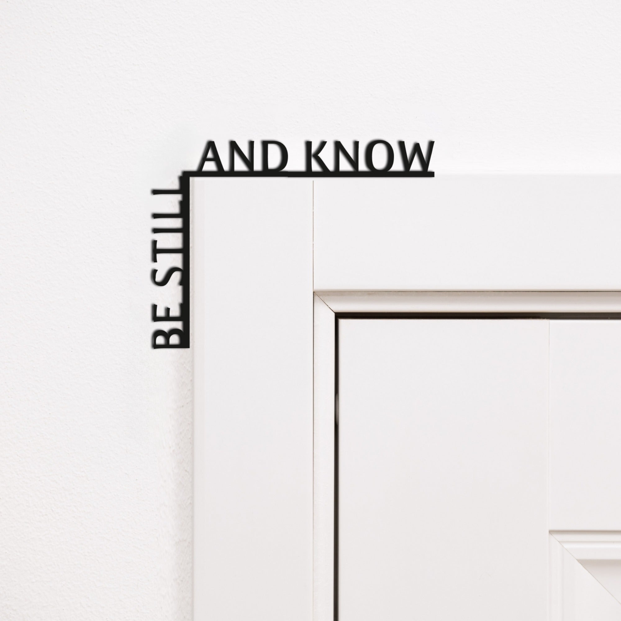 Wooden Be Still and Know wall inscription mounted in a room corner for home mindfulness decor