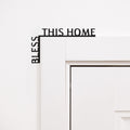 Wooden wall corner sign with the inscription Bless This Home