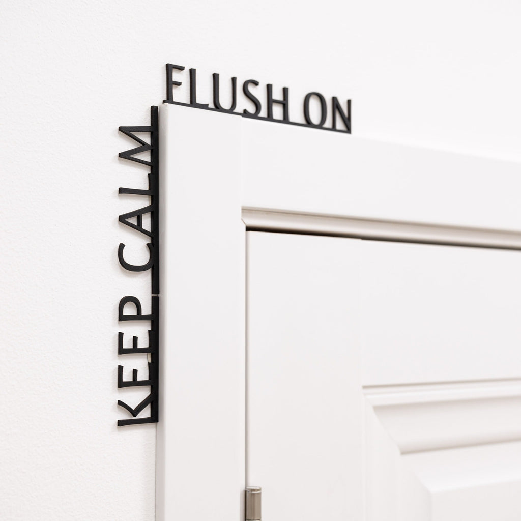 Funny black wooden bathroom sign reading Keep Calm Flush On.