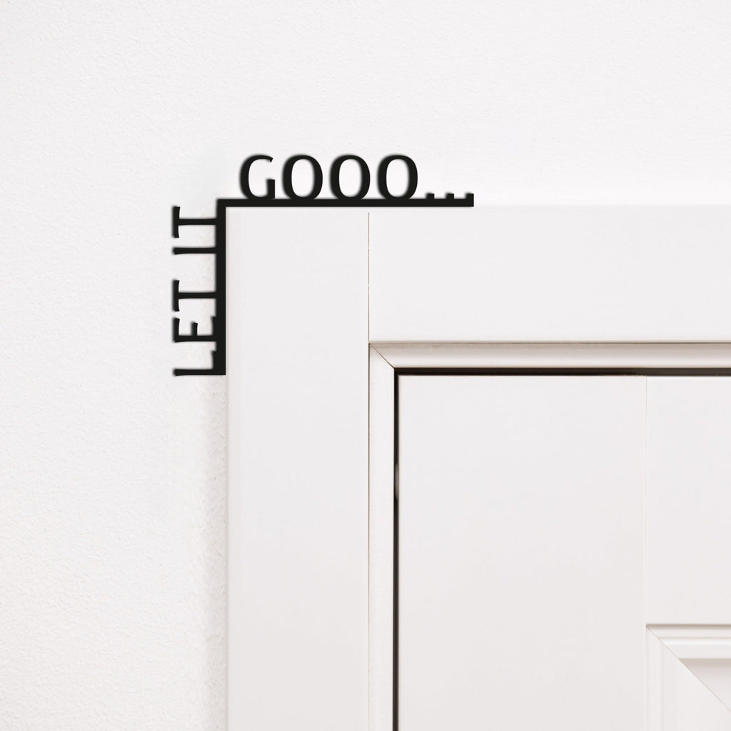 Let It Gooo wooden quote sign mounted in the corner of a living room