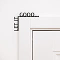 Let It Gooo wooden quote sign mounted in the corner of a living room
