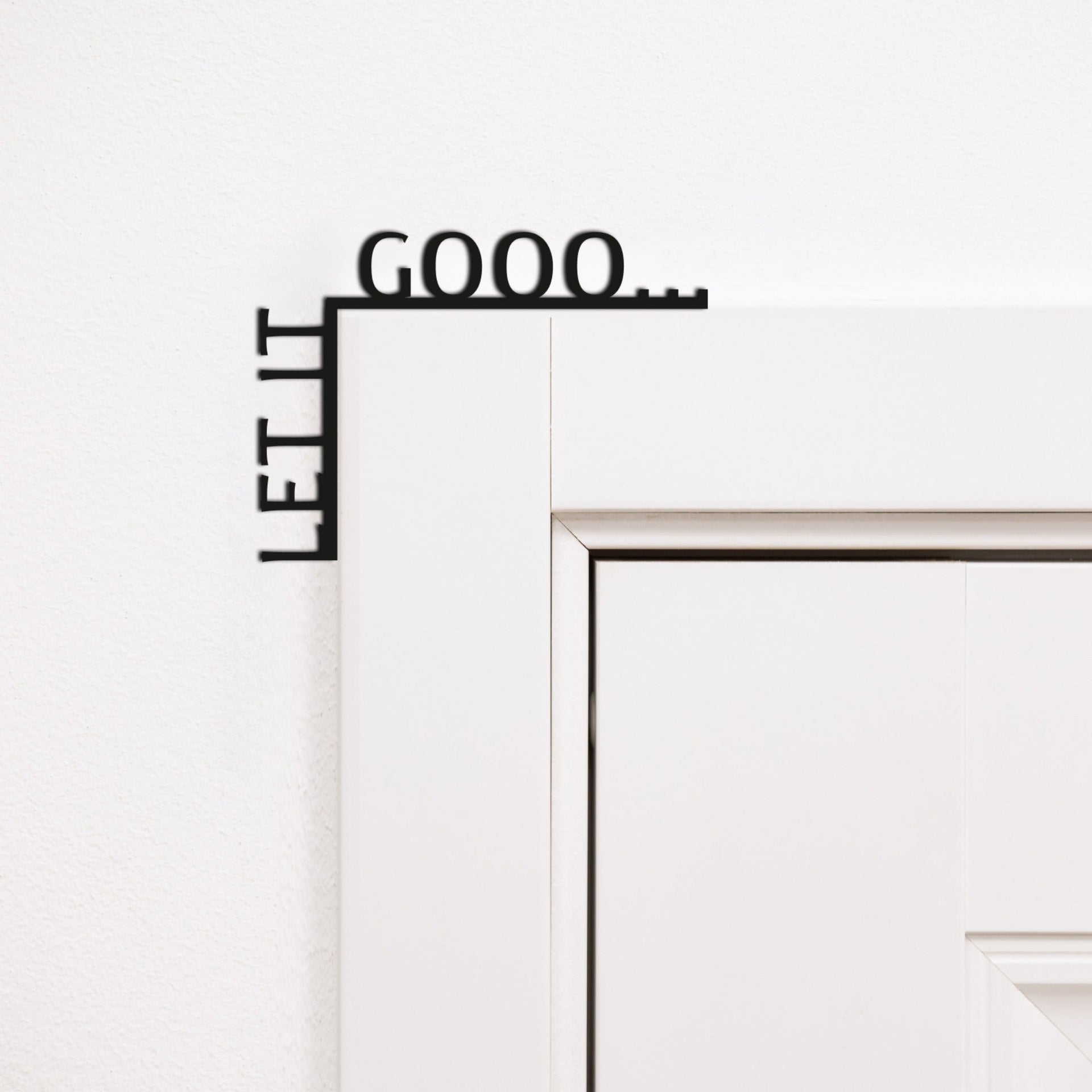 Let It Gooo wooden quote sign mounted in the corner of a living room