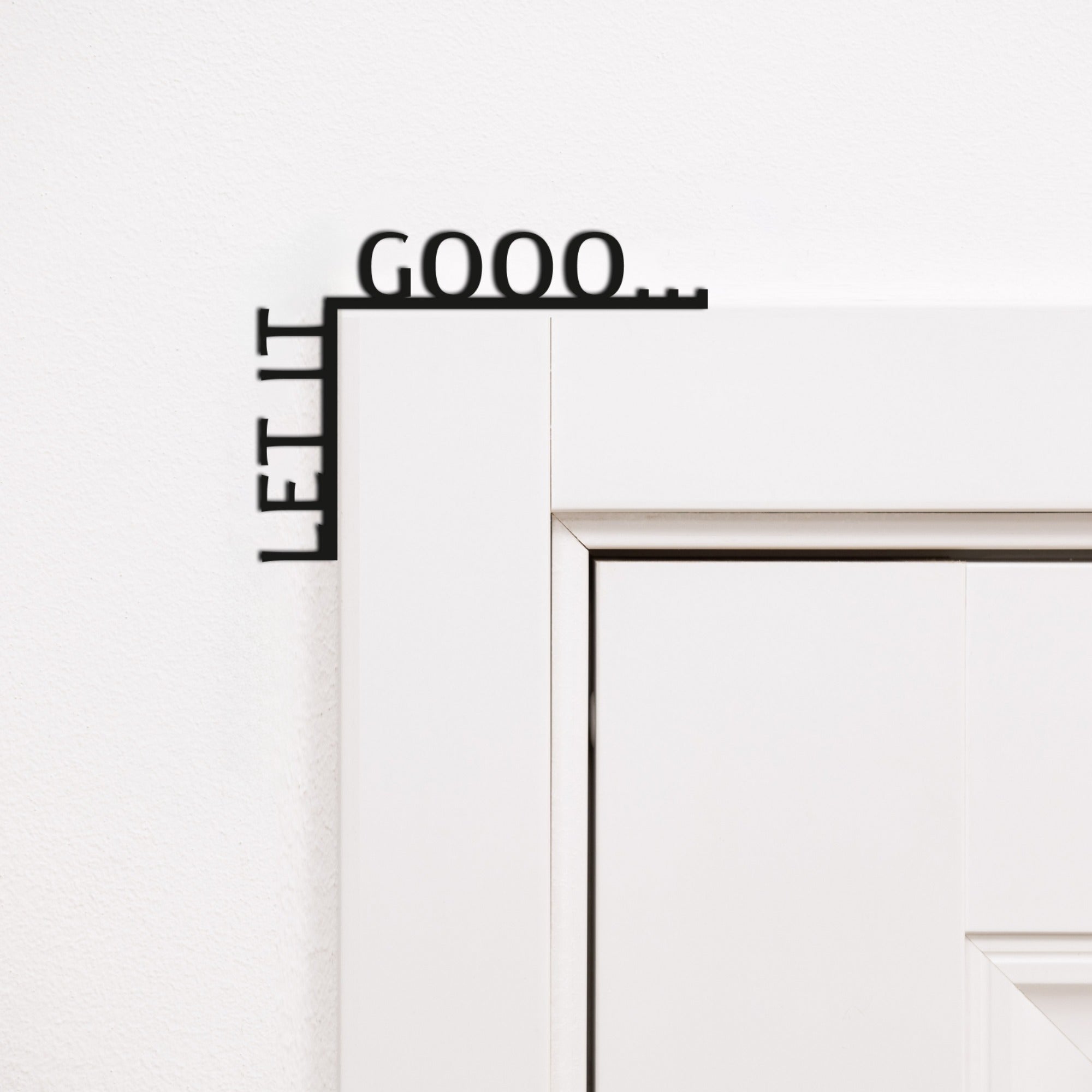 Let It Gooo wooden quote sign mounted in the corner of a living room