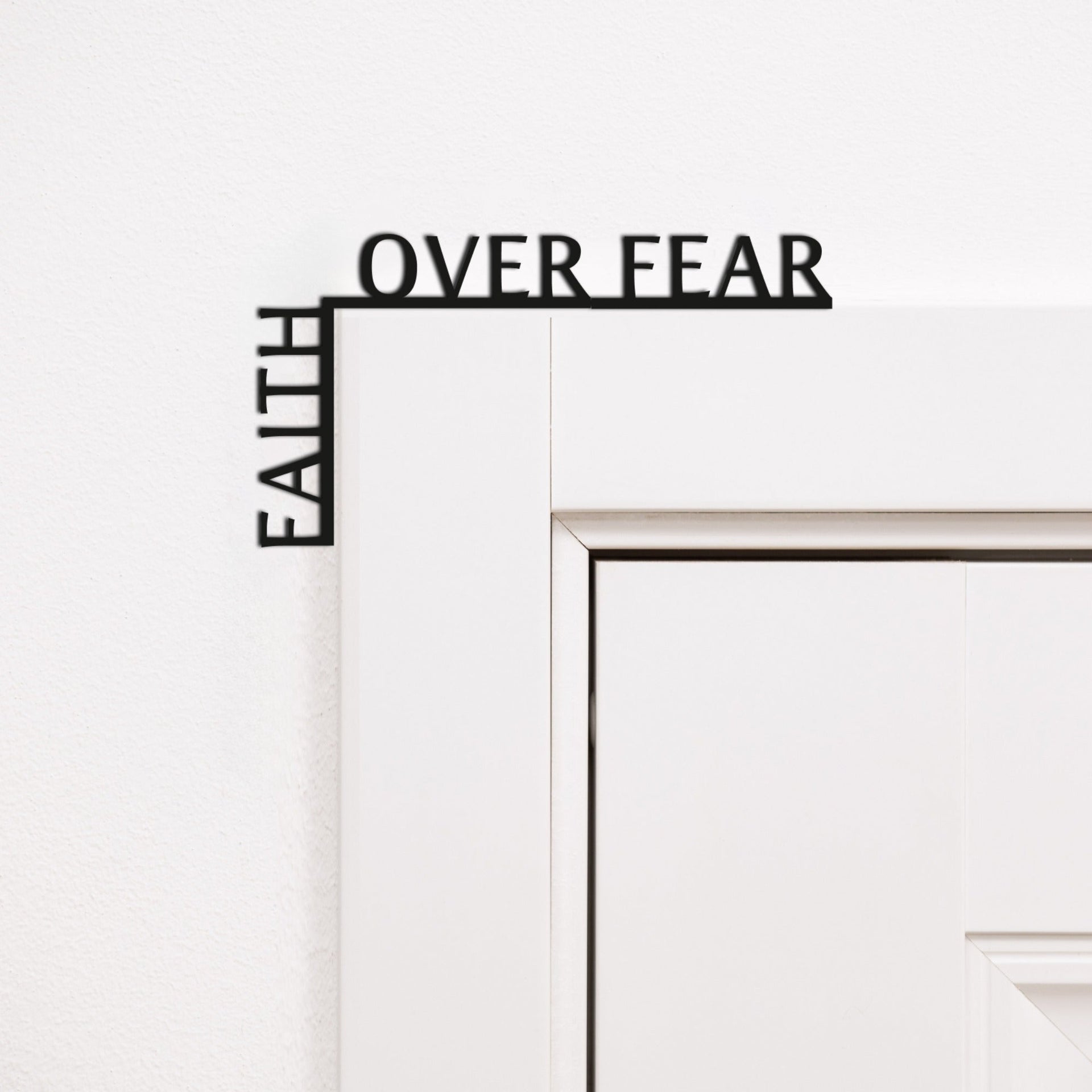 Minimalist black wooden corner quote reading 'Faith Over Fear' for inspirational wall decor.