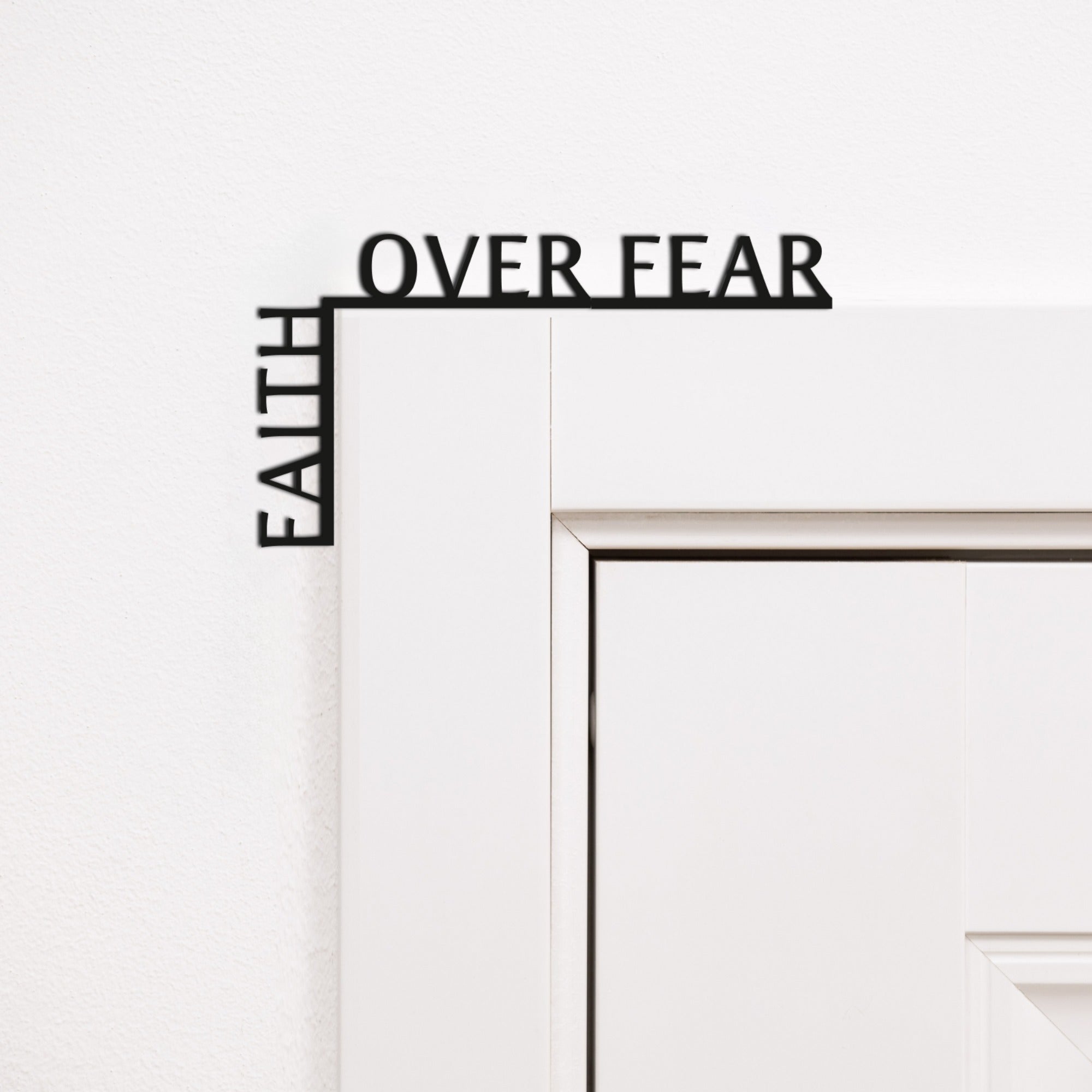Minimalist black wooden corner quote reading 'Faith Over Fear' for inspirational wall decor.