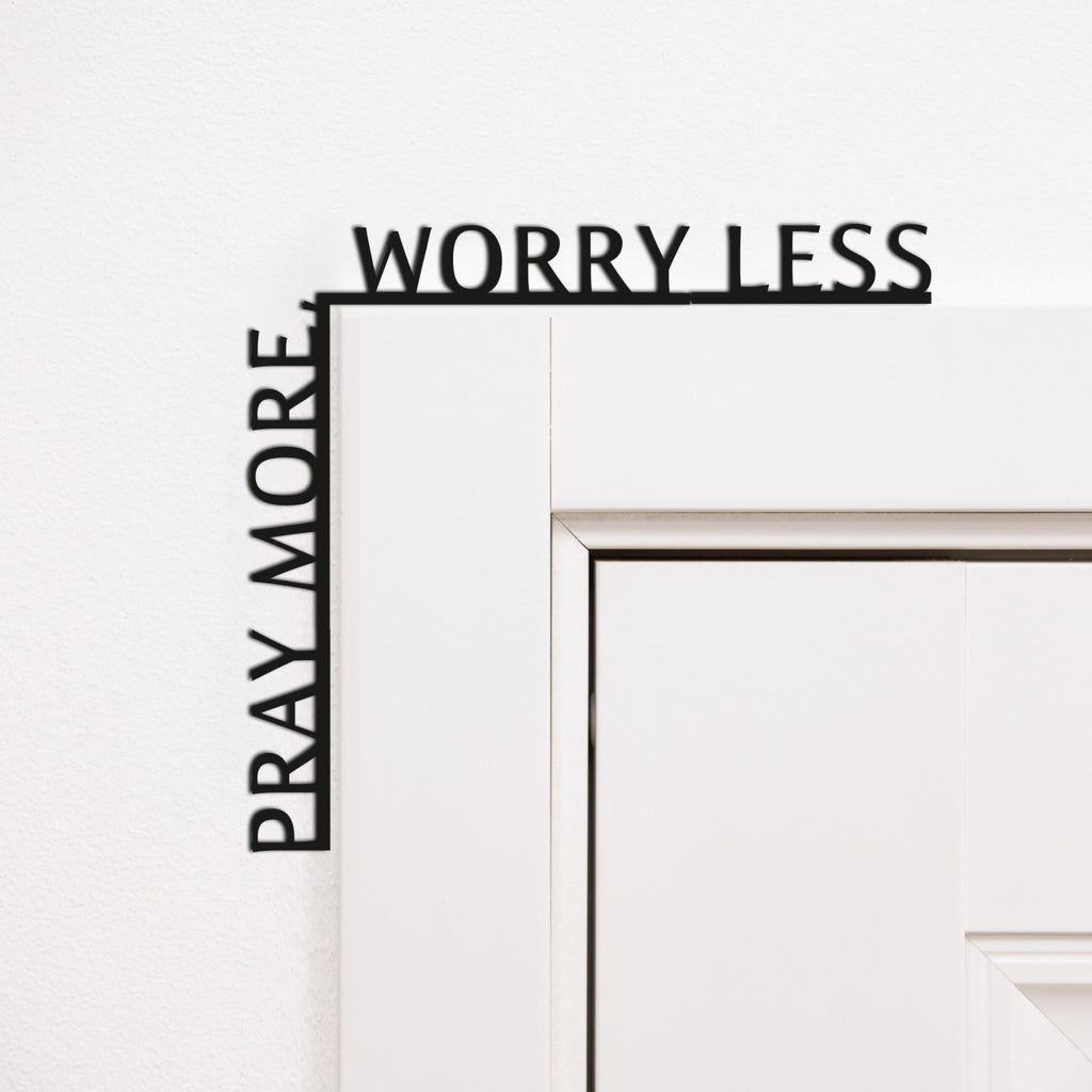 Wooden corner inscription reading Pray More, Worry Less, elegantly displayed as home decor.