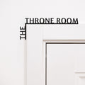 Black wooden corner quote reading 'The Throne Room' for modern bathroom wall decor.
