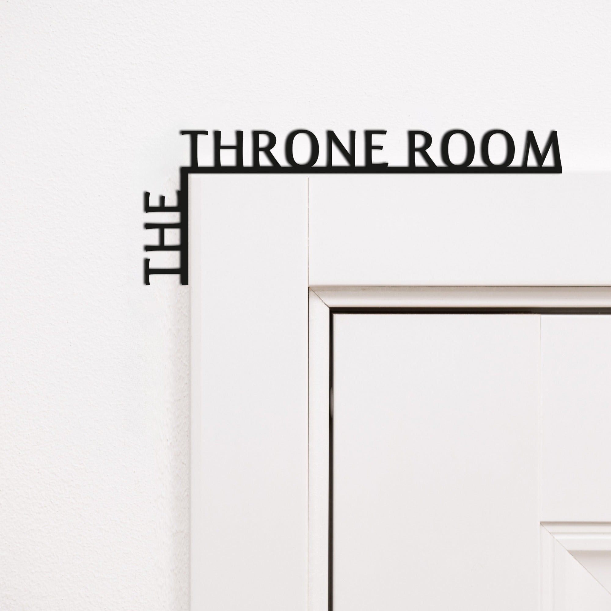 Black wooden corner quote reading 'The Throne Room' for modern bathroom wall decor.