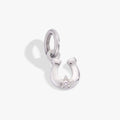 A close-up of a polished 925 sterling silver horseshoe charm with a single round clear crystal in a prong setting.